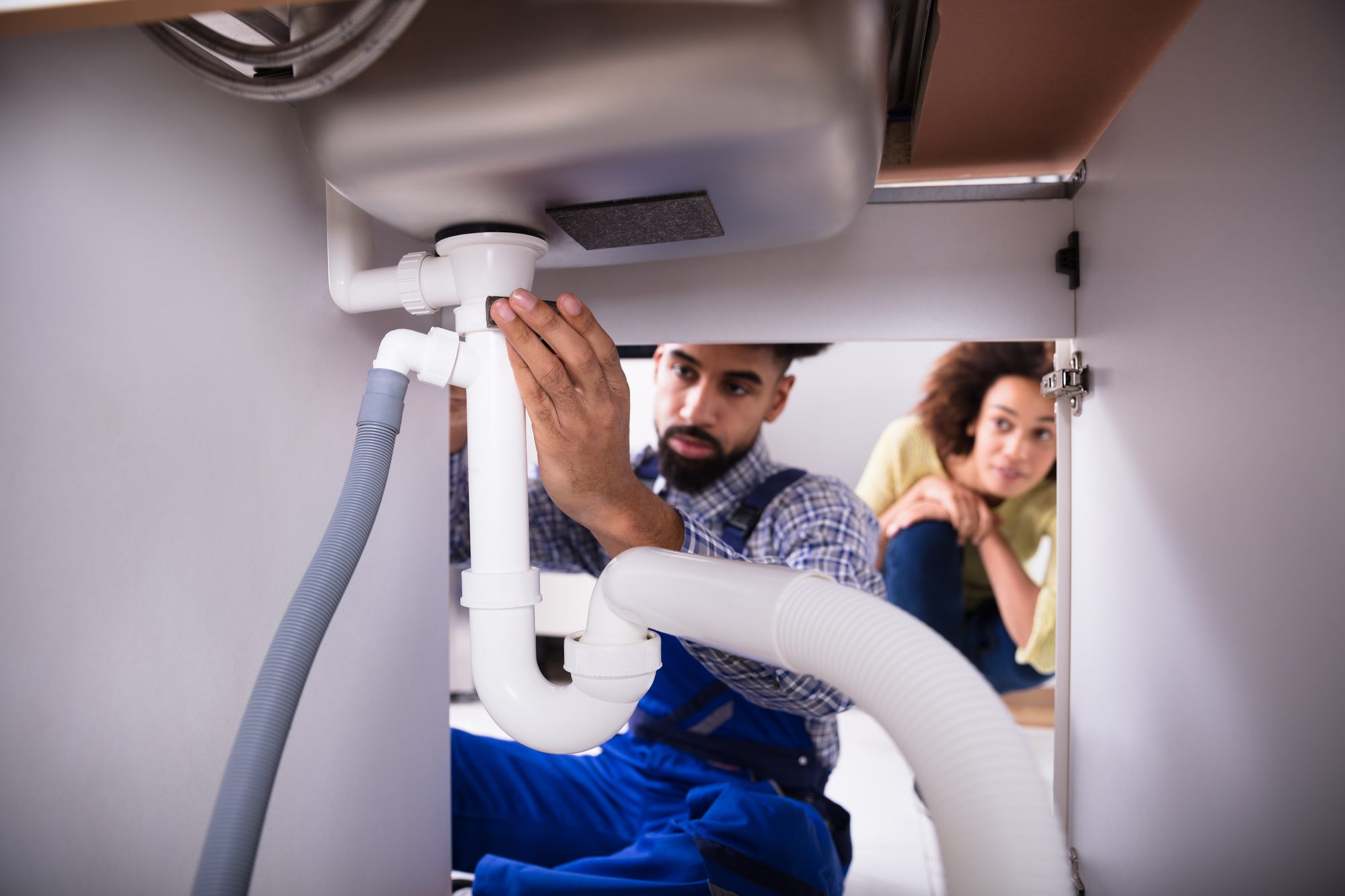 Close-up Of A Male Plumber Fixing Sink
